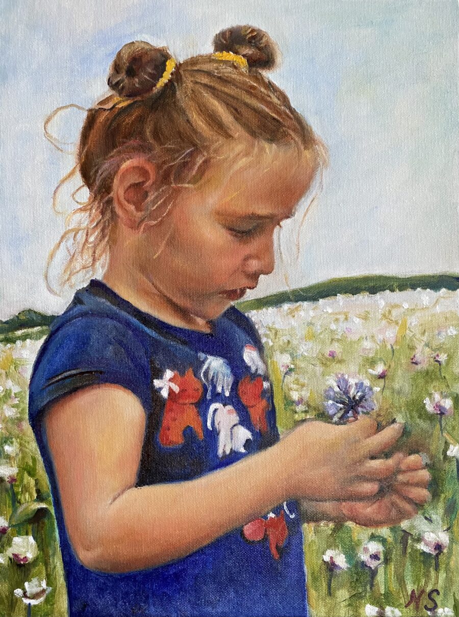 A little girl in a poppy field